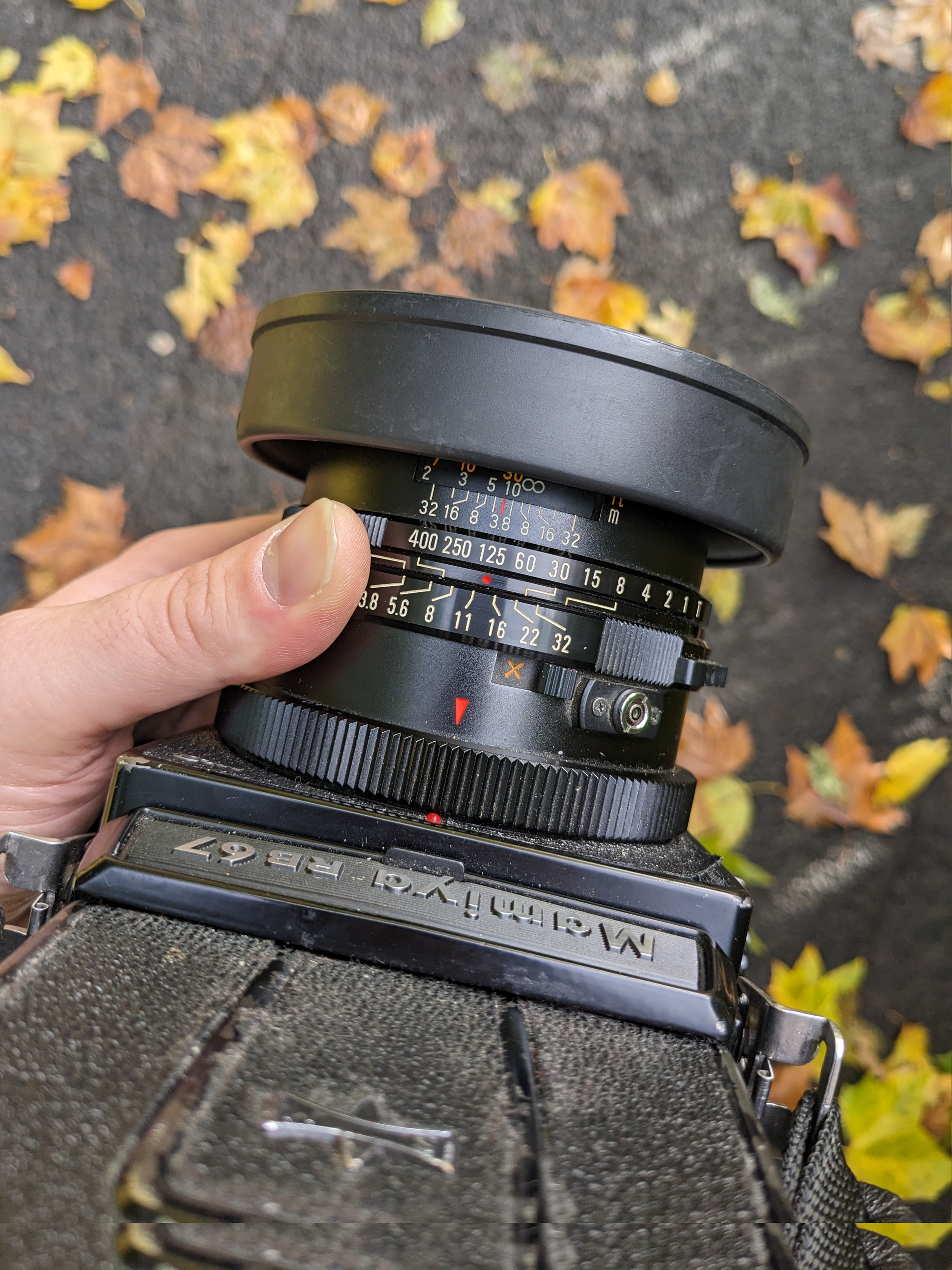 Looking down at a Mamiya RB67 medium format film camera, with the lens and settings dials in focus.